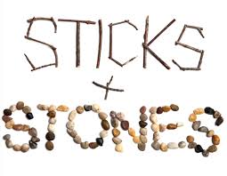 The image tells a unique story with "STICKS + STONES" artfully spelled out using natural materials. Twigs weave the word "STICKS," while an array of colored stones brings "STONES" to life, symbolizing a change in perspective through nature's simplicity.