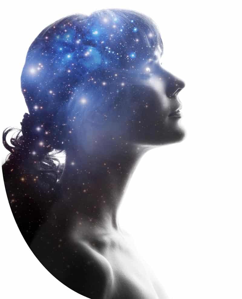 A silhouette of a woman's head and shoulders is overlaid with an image of a galaxy filled with stars and nebulae, evoking a dreamy mindset or cosmic theme. The background is white, highlighting the space imagery within her profile that suggests personal power.